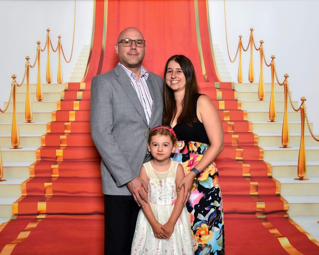 Hannah with her husband and daughter on a cruise ship