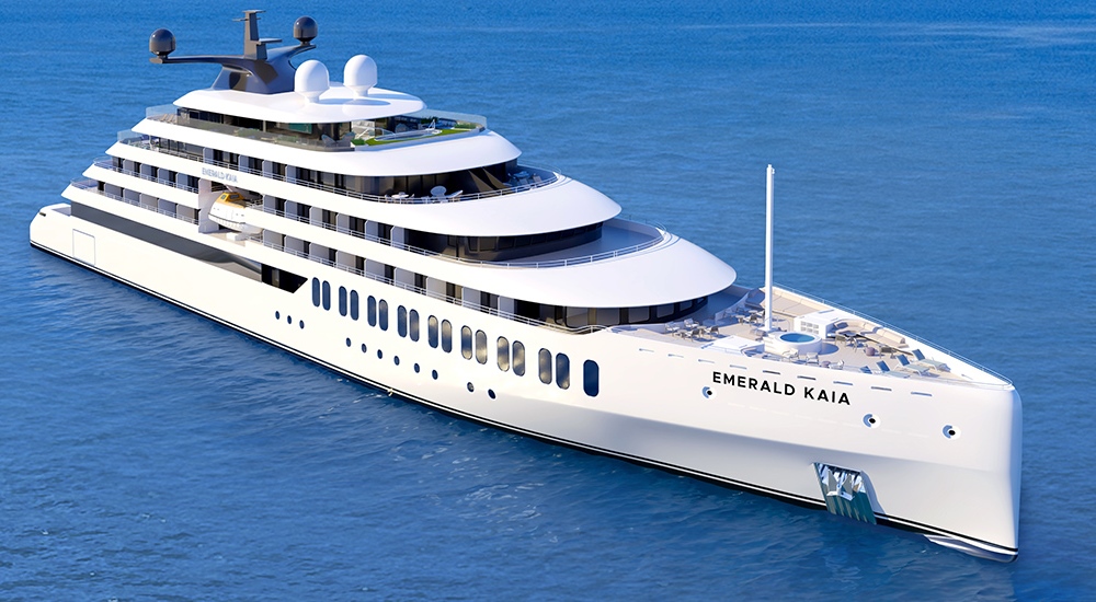 Rendering of Emerald Kaia sailing at sea, showing the yacht’s sleek white exterior, tiered decks with panoramic windows, sun deck areas, and modern superyacht design against calm blue water.
