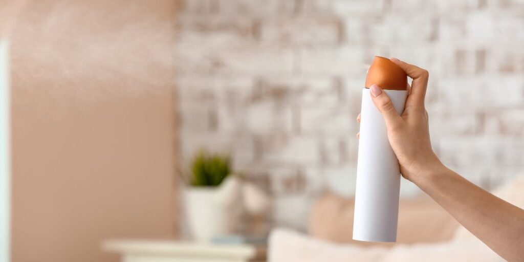 Someone spraying air freshener