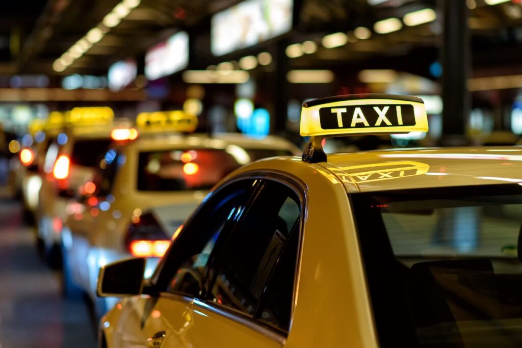 A line of yellow taxi cabs waiting at the airport