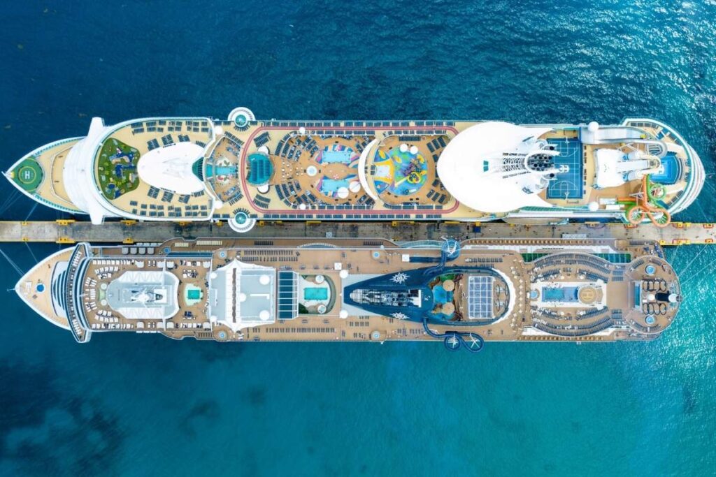 Cruise ships docked side by side in clear blue water at Costa Maya cruise port.