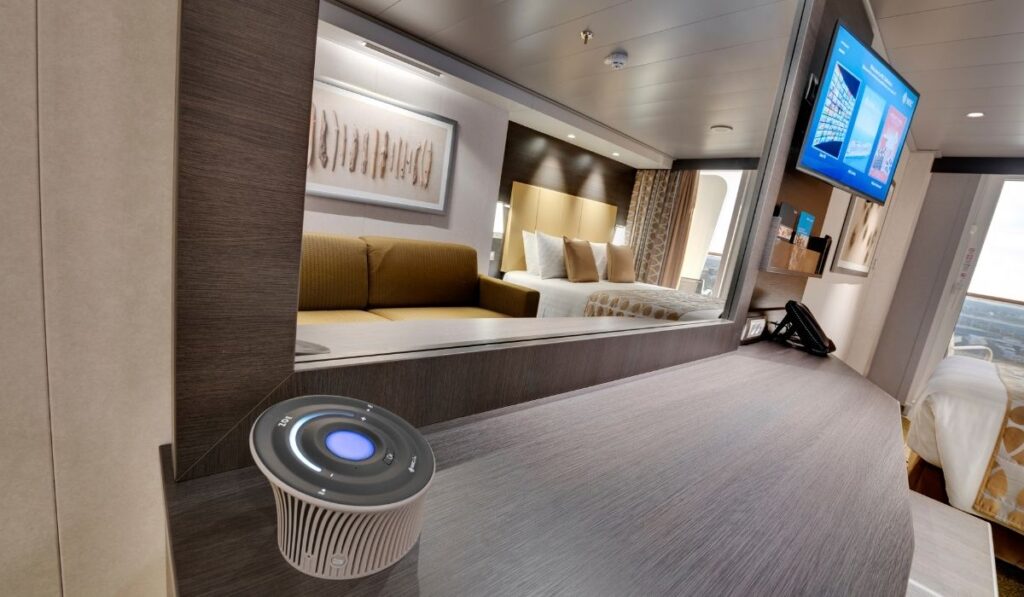 MSC Zoe voice assistant device on a cabin desk inside an MSC cruise ship stateroom.