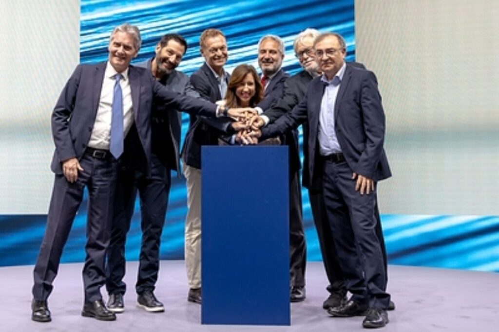 Group of Carnival and shipyard executives place their hands on the ceremonial button during the steel-cutting event for Carnival Destiny in Italy.