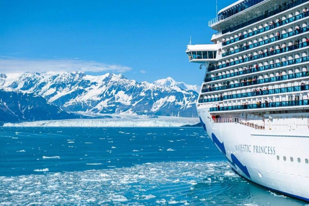 Majestic Princess sailing past glaciers and snow-covered mountains in Alaska.