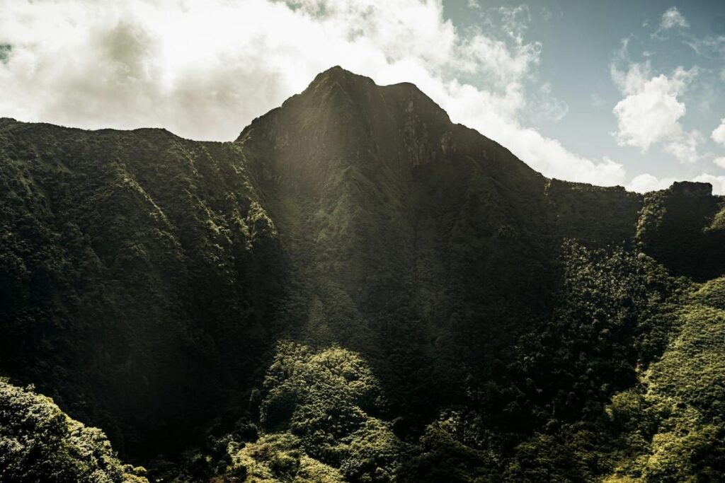 Mount Liamuiga in St. Kitts with steep green slopes and clouds above the peak.
