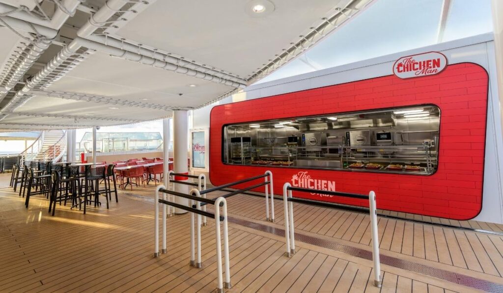 The Chicken Man grab-and-go counter on MSC Seashore with nearby outdoor seating on the pool deck.