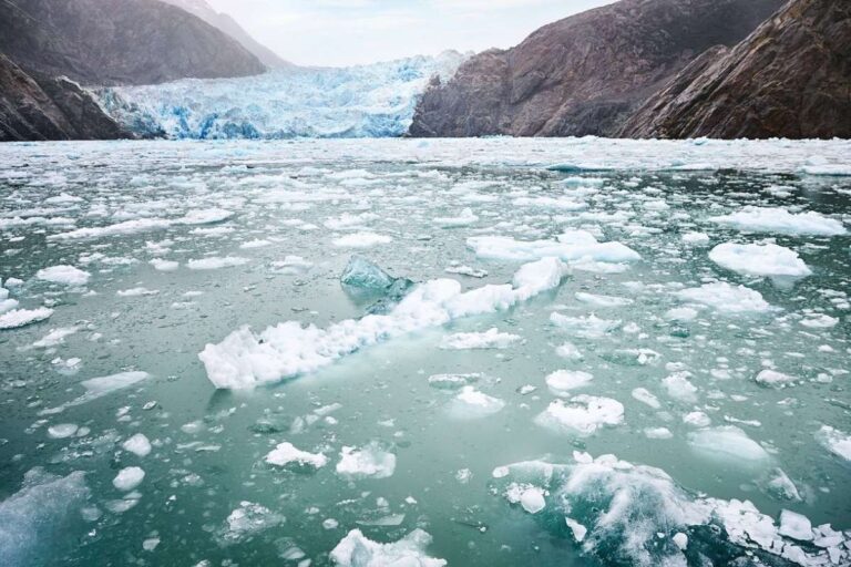 Floating ice in front of Sawyer glacier in Tracy Arm Fjord in Alaska, showing the icy conditions cruise ships can face on scenic glacier routes.