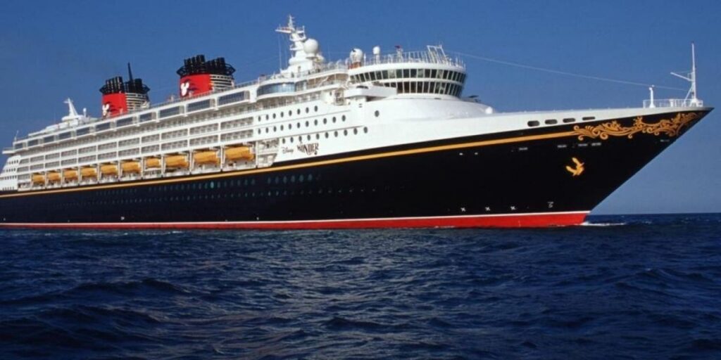Side view of the Disney Wonder at sea under a clear blue sky