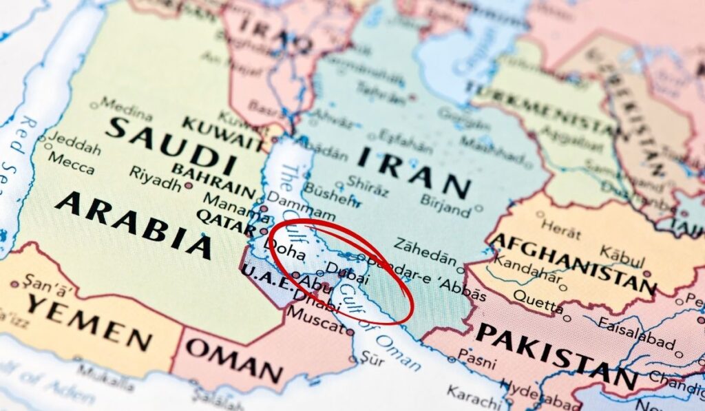 Map of the Middle East with Dubai, Doha and Abu Dhabi circled in red, close to Iran and the Strait of Hormuz.