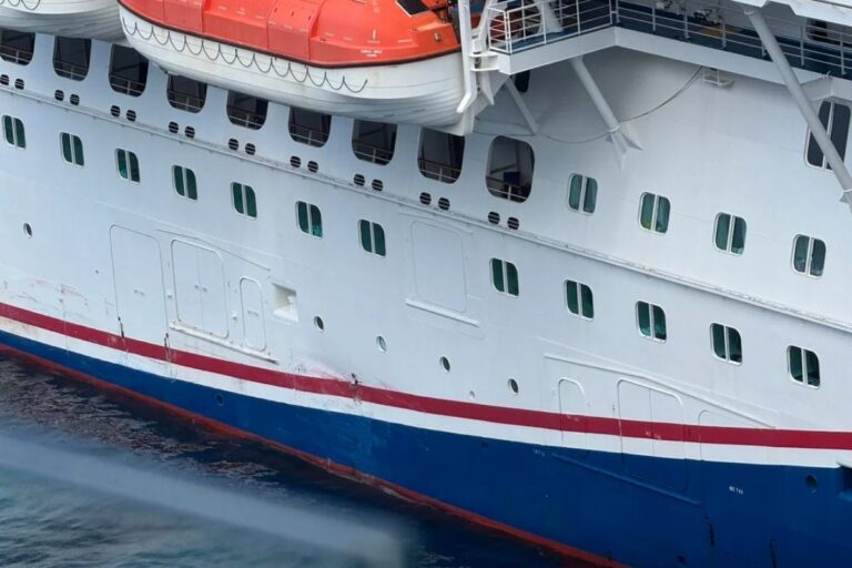 Close-up of Carnival Breeze’s starboard hull showing scraped paint and visible damage near the waterline after the ship made contact with the pier in Cozumel, Mexico.