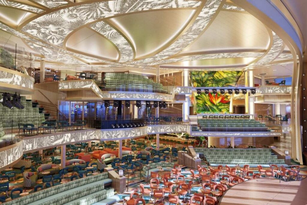 Carnival Tropicale Grand Central atrium with tropical LED displays, tiered seating, and multi-level entertainment spaces.