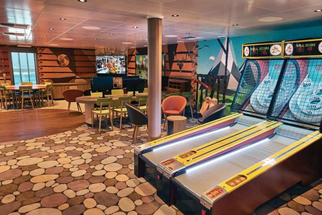 Princess Cruises youth lounge with skee-ball games, tables, and computer stations for kids and teens.