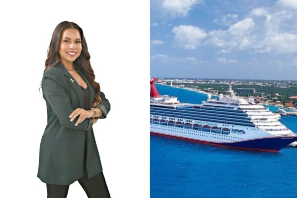 Gabby Gamboa smiling with her arms crossed in a dark green blazer and black outfit, pictured next to a Carnival cruise ship in turquoise water near a tropical shoreline beneath a bright, partly cloudy sky.