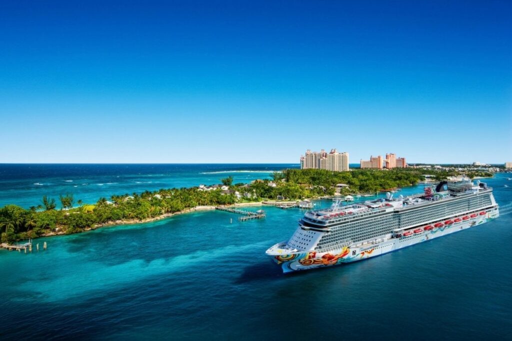 Norwegian Getaway sailing through turquoise waters near Nassau, Bahamas, with Paradise Island and the Atlantis resort visible in the background.