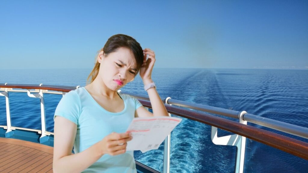 A girl looking at a bill in her hand whilst on a cruise.