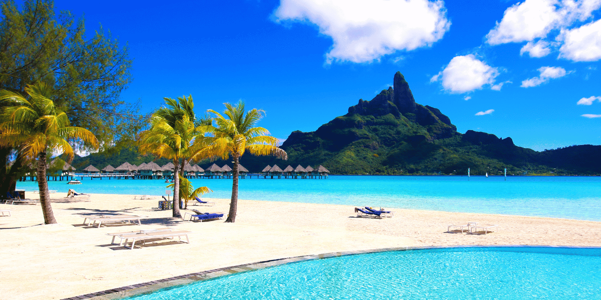 A beautiful beach landscape in Bora Bora, with mountains in the background.