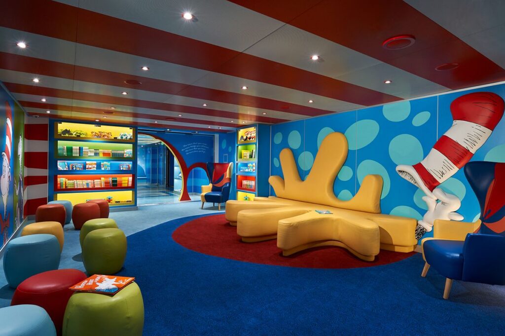 Dr. Seuss Bookville on Carnival Horizon, a colorful and whimsical reading space inspired by the beloved children's author, with polka-dotted walls, bright furniture, and shelves full of books inviting young readers to explore.
