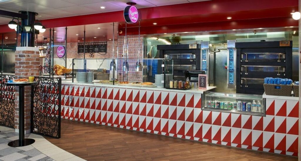 Pizzeria del Capitano on Mardi Gras, a stylish pizzeria with a modern design, featuring a red and white geometric counter and an open kitchen where fresh pizzas are prepared and displayed.