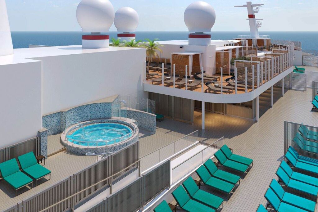 Serenity Adult-Only Retreat on Carnival's Mardi Gras ship featuring a tranquil hot tub, comfortable loungers, and a shaded seating area with ocean views in the background.