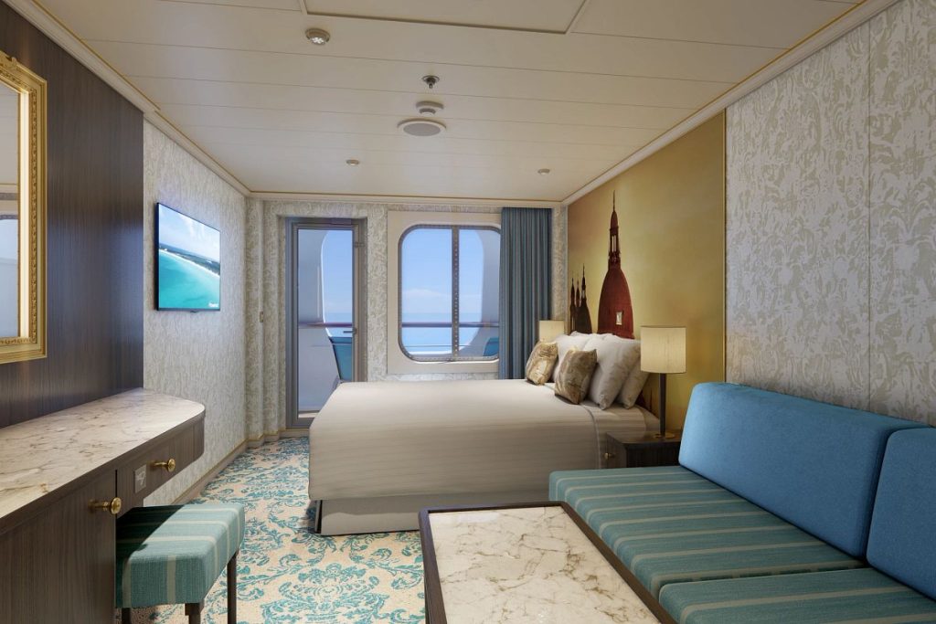 Elegant and cozy cruise ship cove balcony stateroom with a comfortable queen-sized bed, a blue sofa, marble desk, and a mounted TV, with a view of the ocean through the porthole and balcony door.