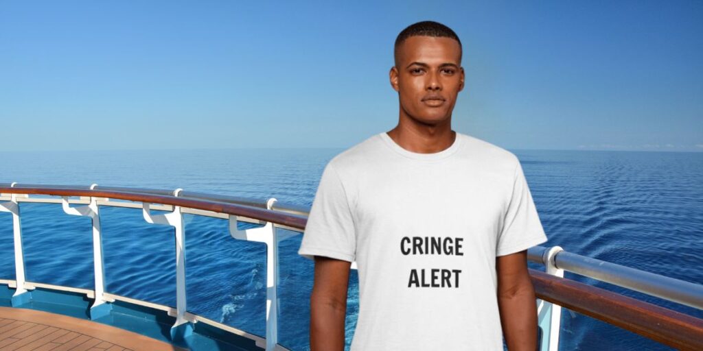 A man wearing a white t-shirt with the text "CRINGE ALERT" is standing on the deck of a ship, with a vast, calm ocean and a clear blue sky in the background. The ship's railing and the open sea create a serene maritime scene.