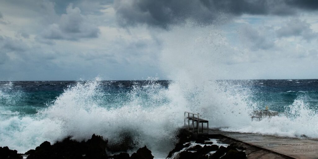Huge waves splashing on the rocks near the shore