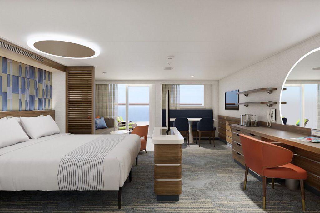 The Excel Suite on Carnival Celebration offers a sleek, modern retreat with a spacious king-size bed, a well-appointed living area leading to a balcony with ocean views, and a stylish workspace, combining luxury and comfort for an exceptional cruise experience.