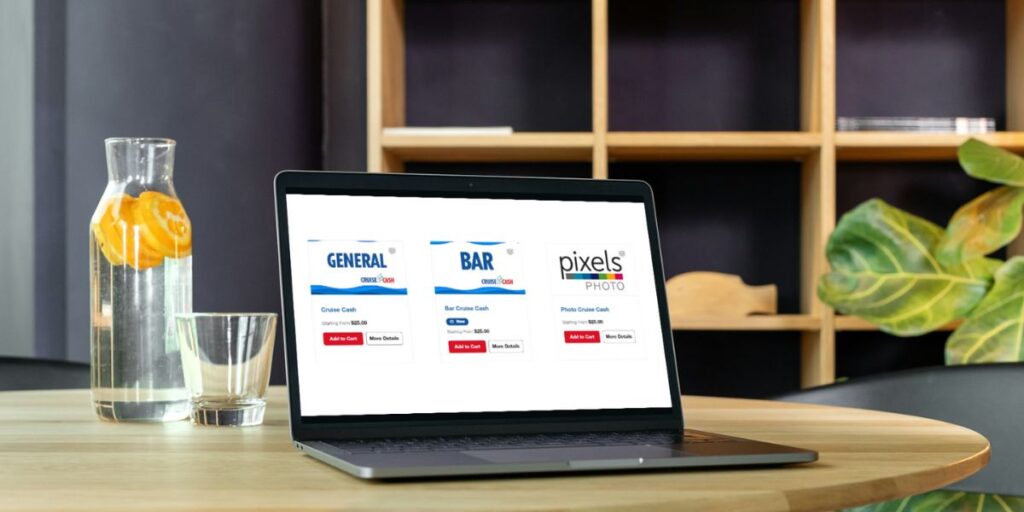 A laptop screen displays options for 'Carnival Cruise Cash' for general, bar, and photo services on a sleek wooden table, accompanied by a refreshing pitcher of water with citrus slices and a modern home office background.