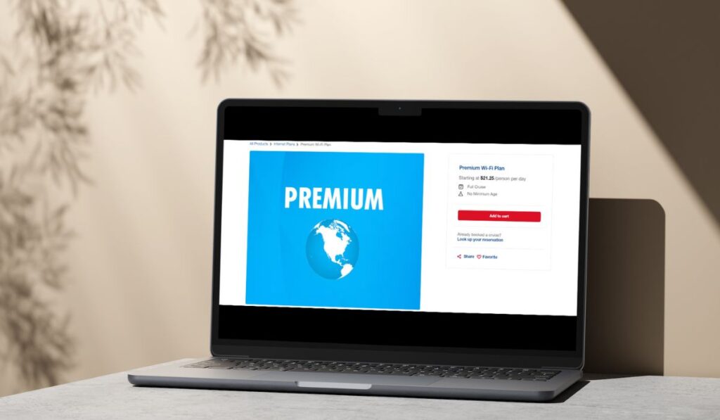 A laptop screen displaying a Carnival Cruise premium Wi-Fi plan advertisement. The screen shows a large "PREMIUM" label over a globe graphic with a blue background. On the right side, details of the Wi-Fi plan are visible, stating "Premium Wi-Fi Plan Starting at $21.25/person per day" with options to "Add to cart" and additional information such as "Full Cruise" and "No Minimum Age." There are also buttons for "Share" and "Favorite."