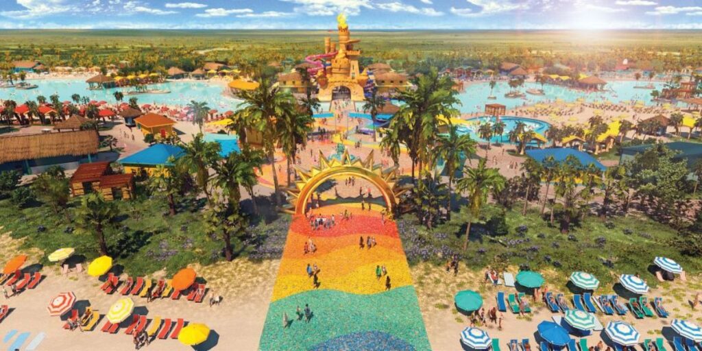 Guests relax under pink and white striped umbrellas at Celebration Key's beachfront pool, with ocean views stretching to the horizon and sailboats in the distance. The scene features a large, curving pool, tropical landscaping, and a laid-back atmosphere perfect for sunbathing and seaside lounging.