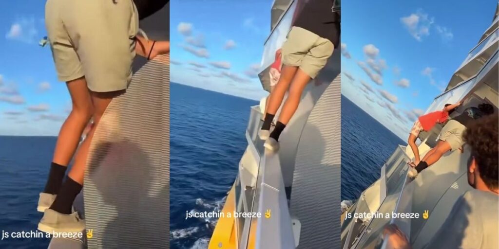 Two teenagers are seen climbing between cruise ship balconies high above the ocean, balancing on narrow ledges with open water below. One holds onto a railing while another leans across to the next cabin as the text “js catchin a breeze ✌️” appears on screen, highlighting the dangerous stunt against a calm blue sea and clear sky.