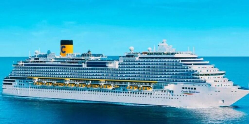 The elegant Costa Diadema cruise ship glides over serene ocean waters, its numerous decks and lifeboats on display, topped with the iconic yellow funnel featuring the Costa emblem, set against a soft blue sky.