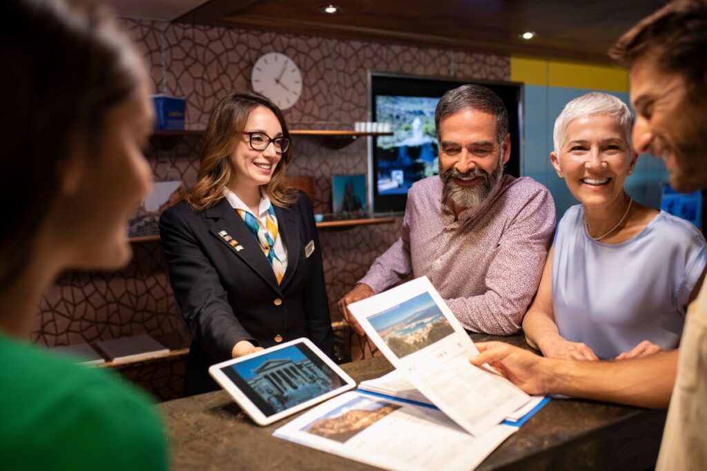 Costa cruises staff and passengers looking happy while looking at the pictures of their next port destination