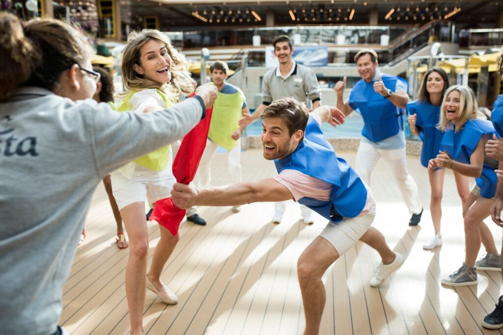 Costa cruise guests playing a team building game with a cruise staff as a supervisor