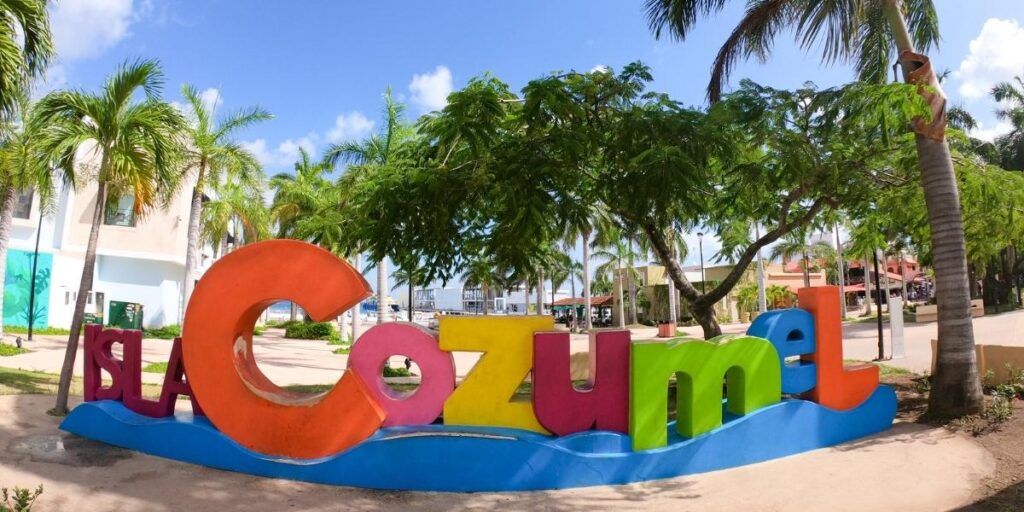 Colourful “Cozumel” sign surrounded by palm trees in Cozumel, Mexico, near the cruise port.