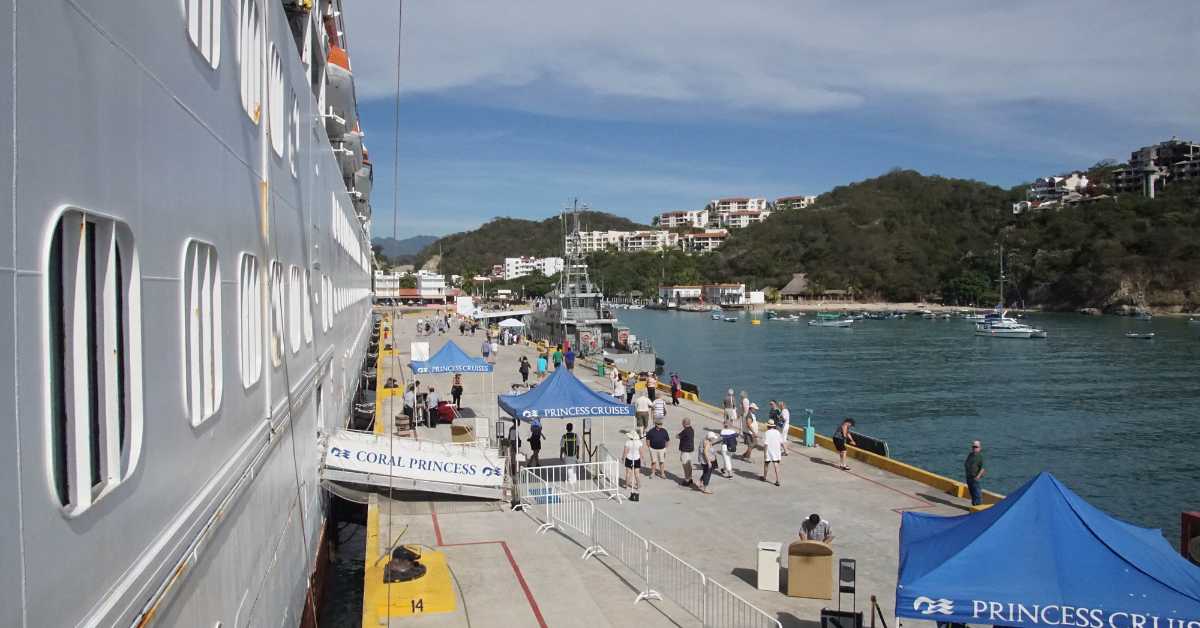 Passengers disembark a cruise ship in a port in Mexico