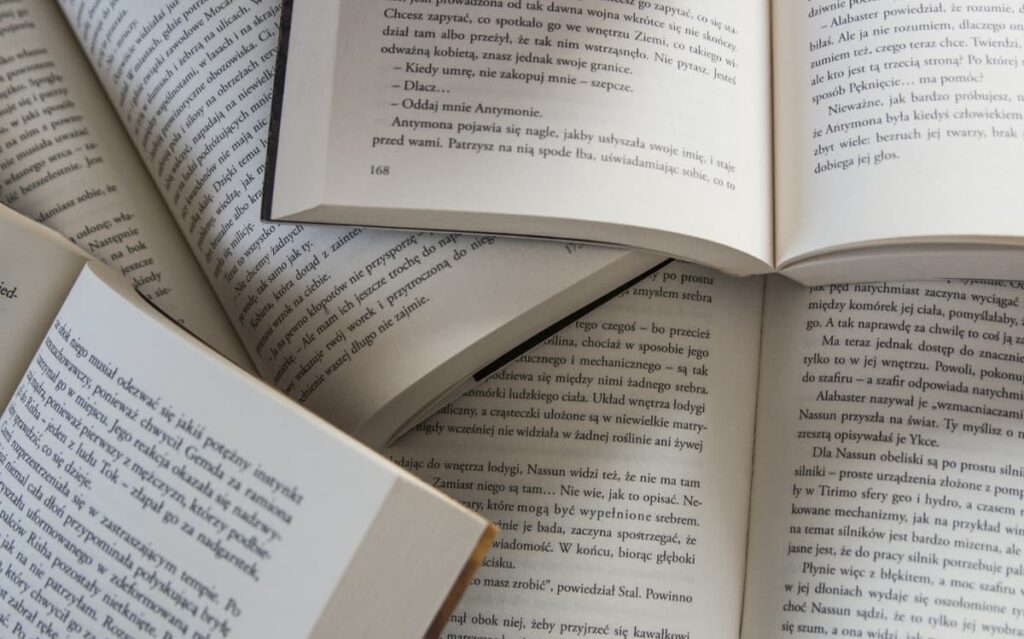 Open book pages showcasing written text, suggesting the availability of reading materials within the cruise ship cabin.