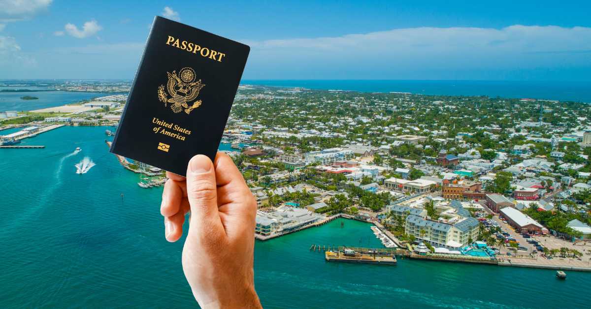 Someone holding a US passport, with a background fo Ke West in Florida, USA.