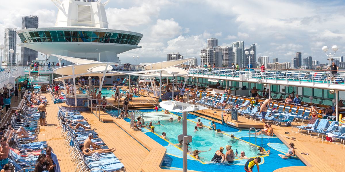 Pool deck on a cruise ship with a ton of cruise ship passengers on enjoying