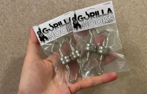 A hand holding magnetic hooks