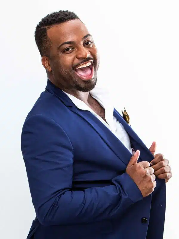 Jonathan “Cookie” Adams smiling in a portrait photo, wearing a blue blazer against a white background.