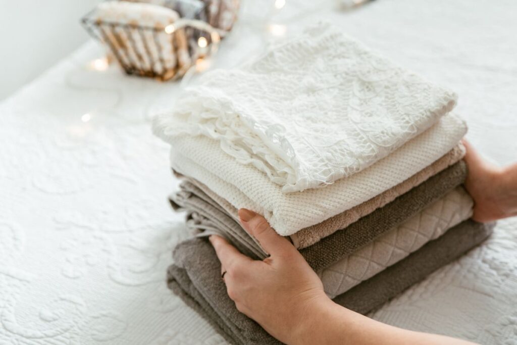 Cruise ship passenger folding their clothes after being laundried
