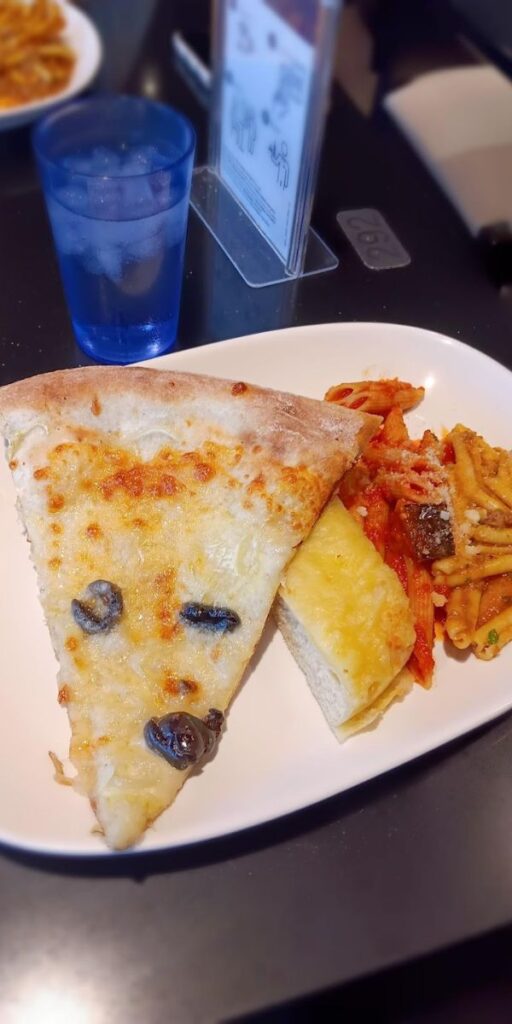 An italian meal on MSC Euribia consisting of a slice of pizza and pasta 