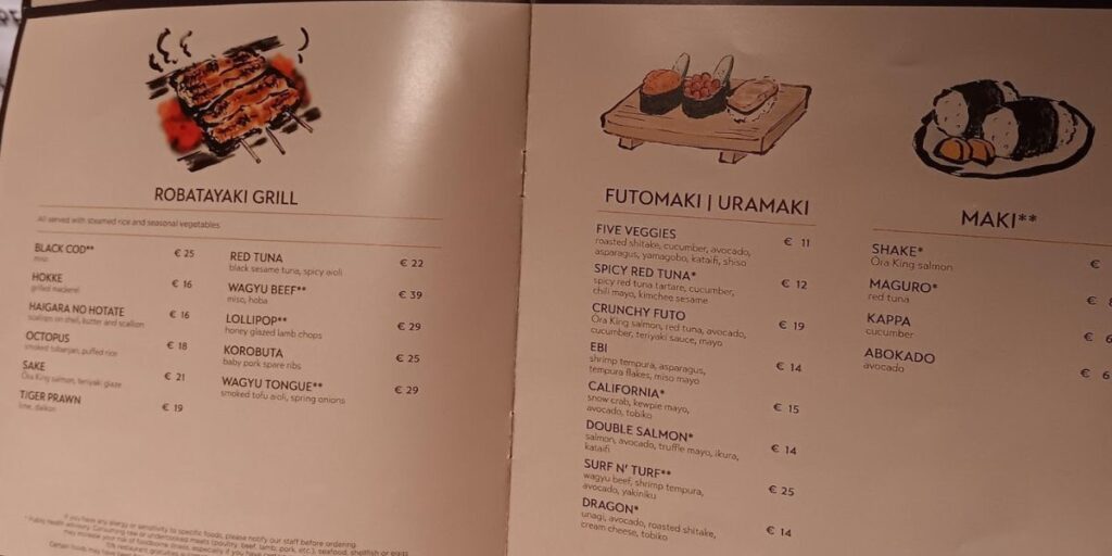 Japanese cuisine menu featuring a 'Robatayaki Grill' with items like 'Black Cod' and 'Wagyu Beef,' and sushi selections such as 'Futomaki / Uramaki' with 'Five Veggies' and 'Spicy Red Tuna,' and 'Maki' rolls including 'Shake' (Ora King salmon) and 'Maguro' (red tuna). Each dish is accompanied by illustrations and prices, inviting patrons to explore a range of grilled delicacies and sushi options.
