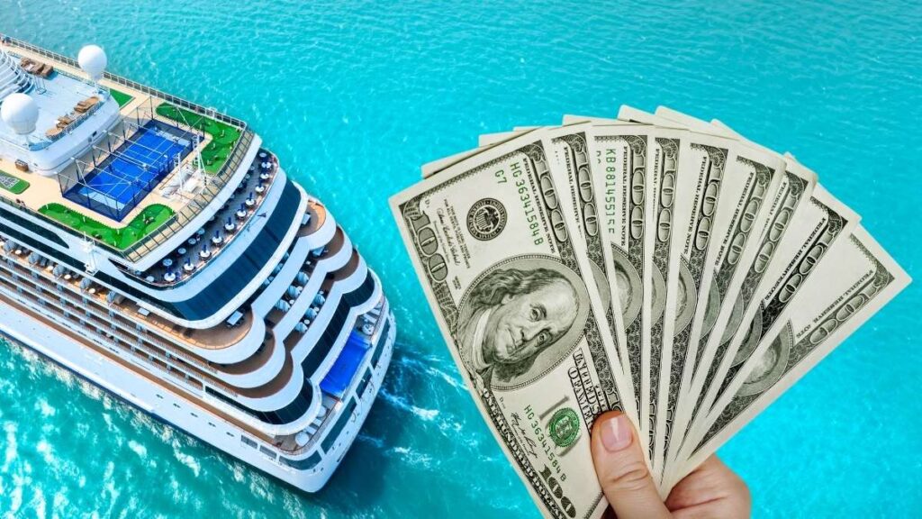 An aerial view of a luxury cruise ship sailing on vibrant turquoise waters, featuring multiple decks, a tennis court, and lounge areas. In the foreground, a hand holds a fan of $100 bills, symbolizing the financial aspect of cruising or travel expenses.