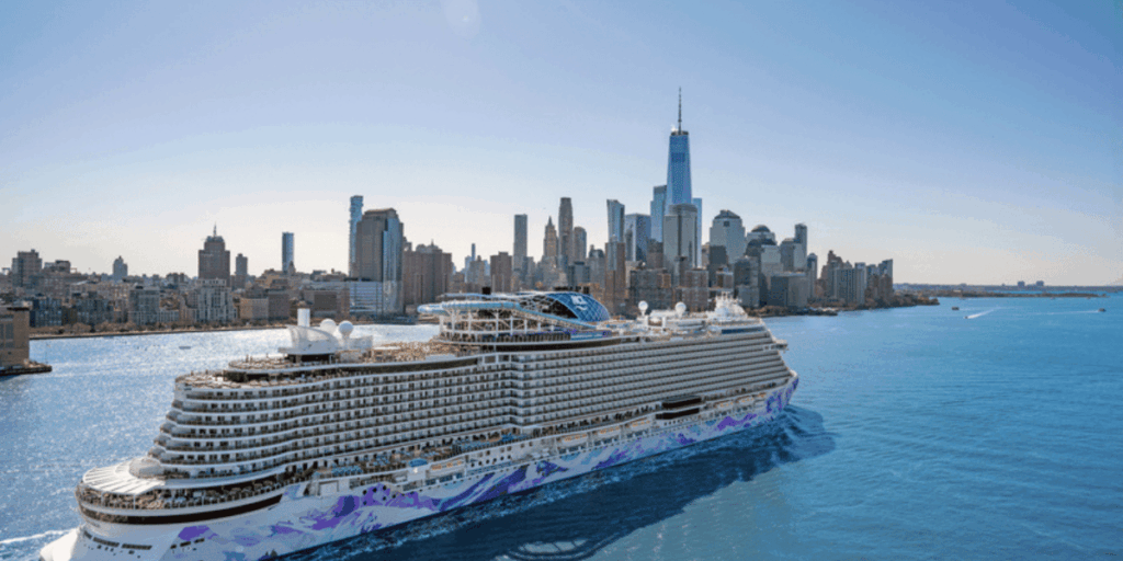 Rendering of Norwegian Luna sailing past the New York City skyline, showing the ship’s sleek Prima Plus design with tiered balconies and expansive outdoor decks on a clear day.