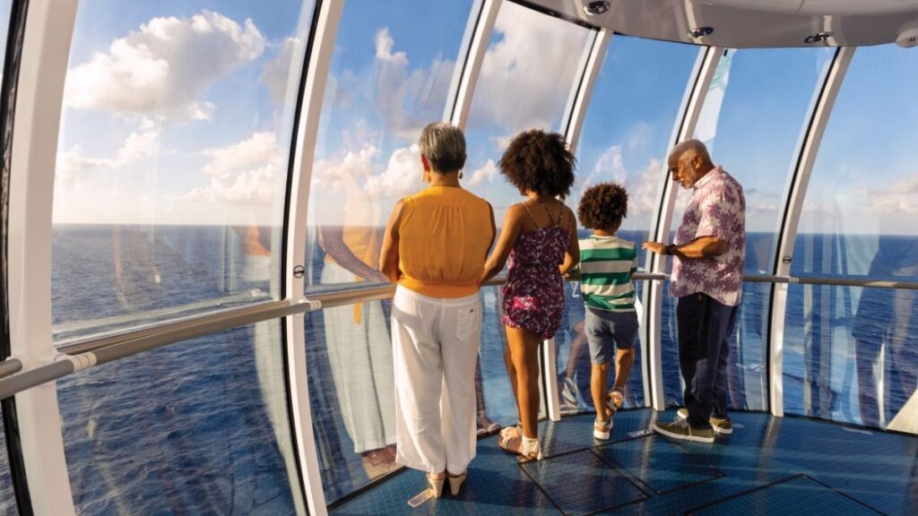 Four people looking out to sea on the North Star on Odyssey of the seas, Royal Caribbean ship.