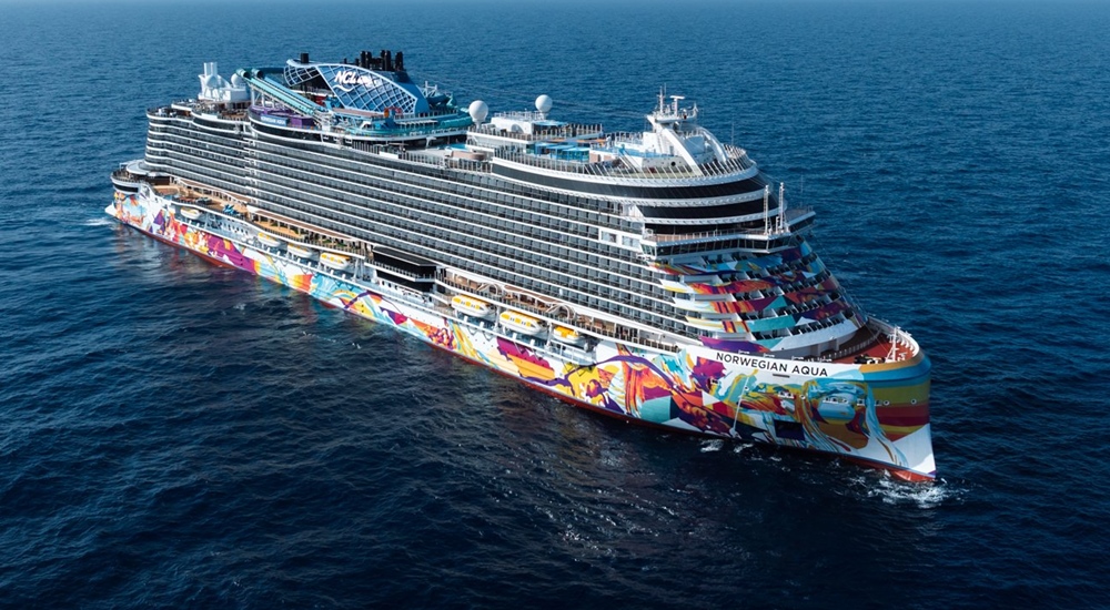 Norwegian Aqua cruise ship sailing through open blue water, viewed from above at an angle.