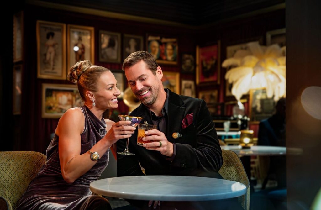 Couple enjoying cocktails together in an elegant Princess Cruises lounge during a child-free evening out.