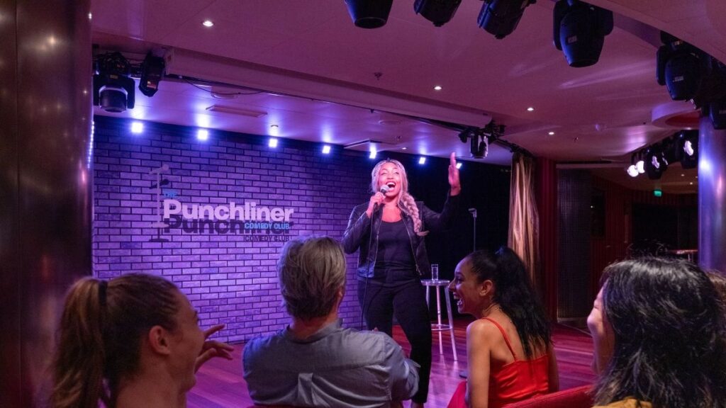 A stand up comedian performing at the Punchliner comedy club on a Carnival Cruise